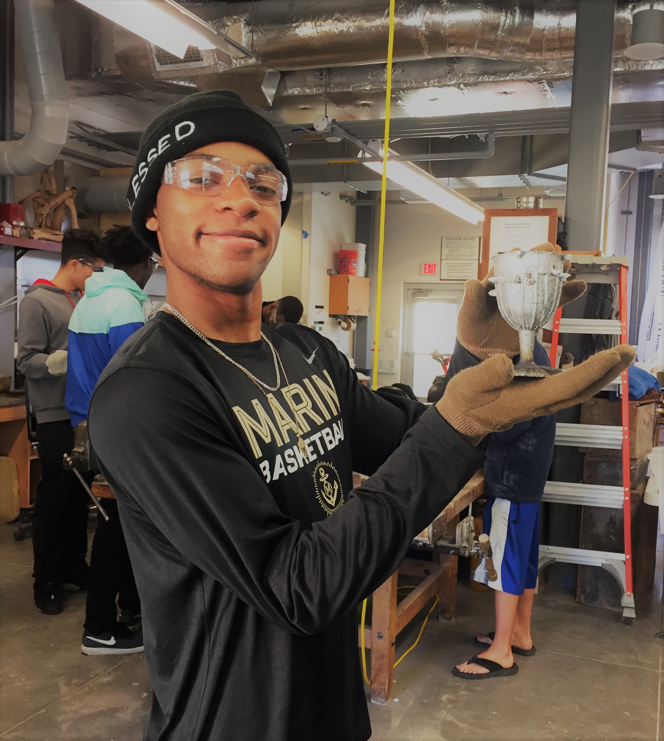 Student in art studio holding chalice