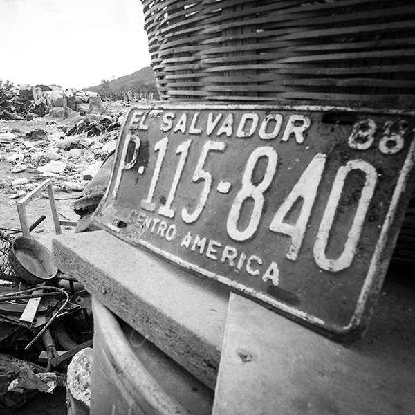 Image of a license plate from El Salvador at a landfill