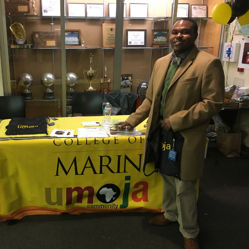 d’Artagnan Connor working COM Umoja booth at an event